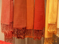 Six cashmere and silk shawls in warm rose, copper, red and gold colours